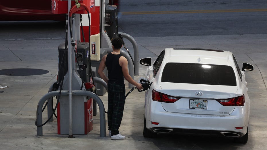 A driver fills up a car at a gas station on January 23, 2023 in Miami, Florida.
