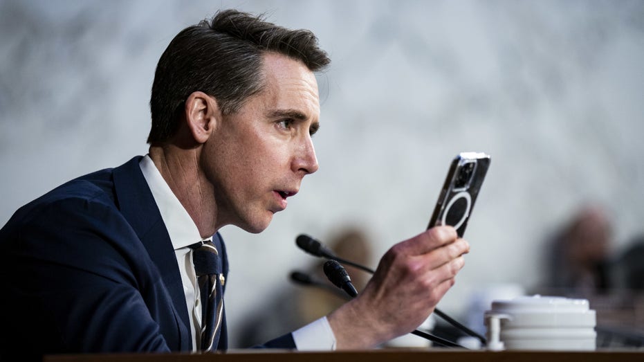 Josh Hawley with phone in hand