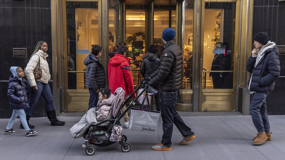 shoppers walk by business