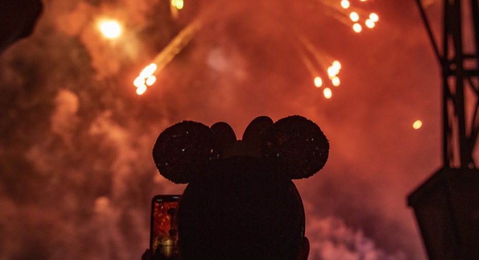 A person watches fireworks at Disney World in Florida