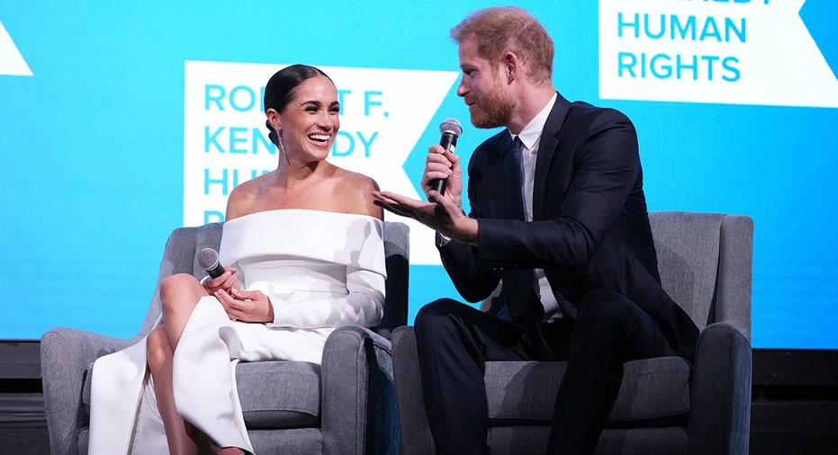 Prince Harry and Meghan on stage