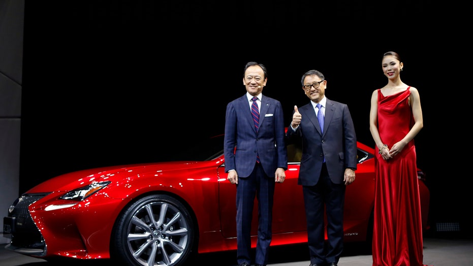 Toyota Motor Corp President Toyoda poses with Ise and Mori at the 43rd Tokyo Motor Show in Tokyo