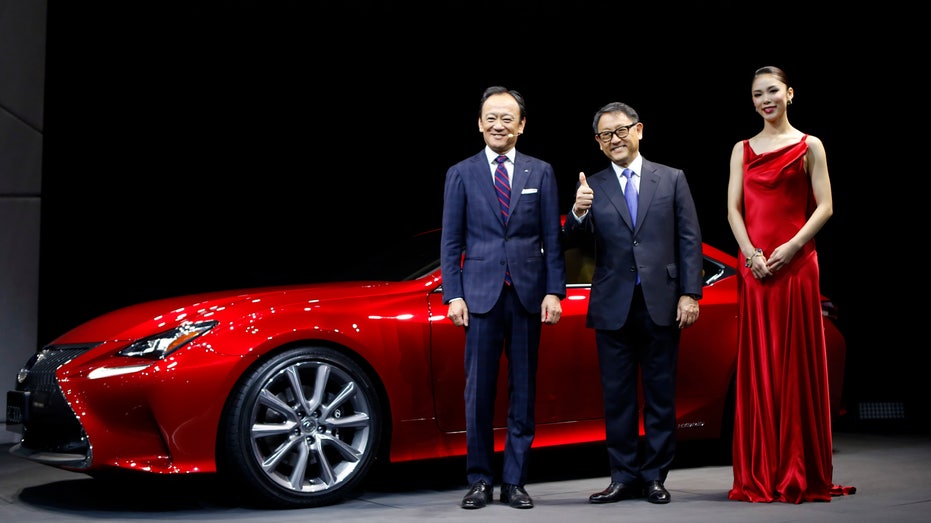 Toyota Motor Corp President Toyoda poses with Ise and Mori at the 43rd Tokyo Motor Show in Tokyo