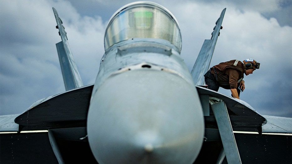 F/A-18E Super Hornet is cleaned on USS Gerald Ford