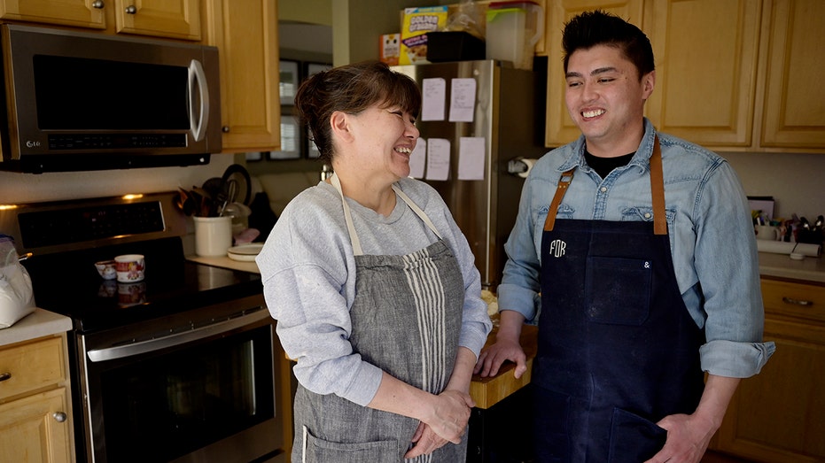 Son cooks with mom in kitchen