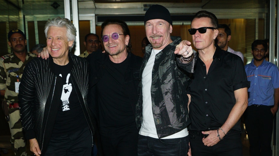 U2 band members L to R Adam Clayton, Bono, The Edge, and Larry Mullen Jr arrive at airport