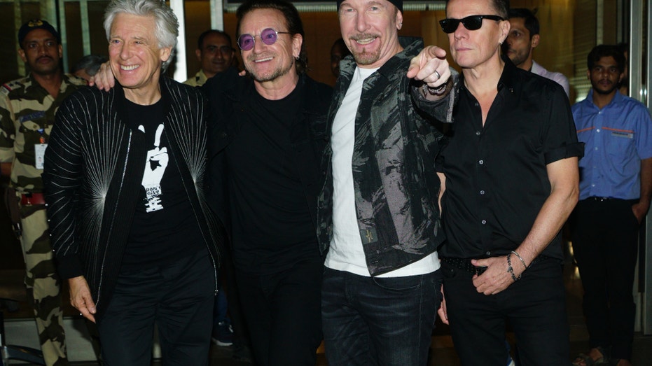 U2 band members L to R Adam Clayton, Bono, The Edge, and Larry Mullen Jr arrive at airport