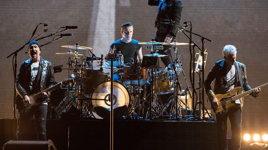 U2 performs on stage on tour