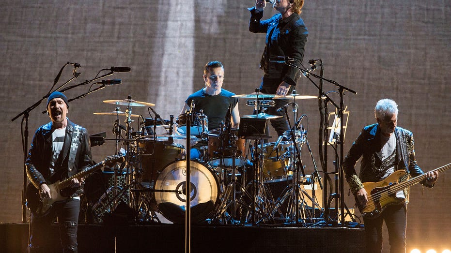 U2 performs on stage on tour