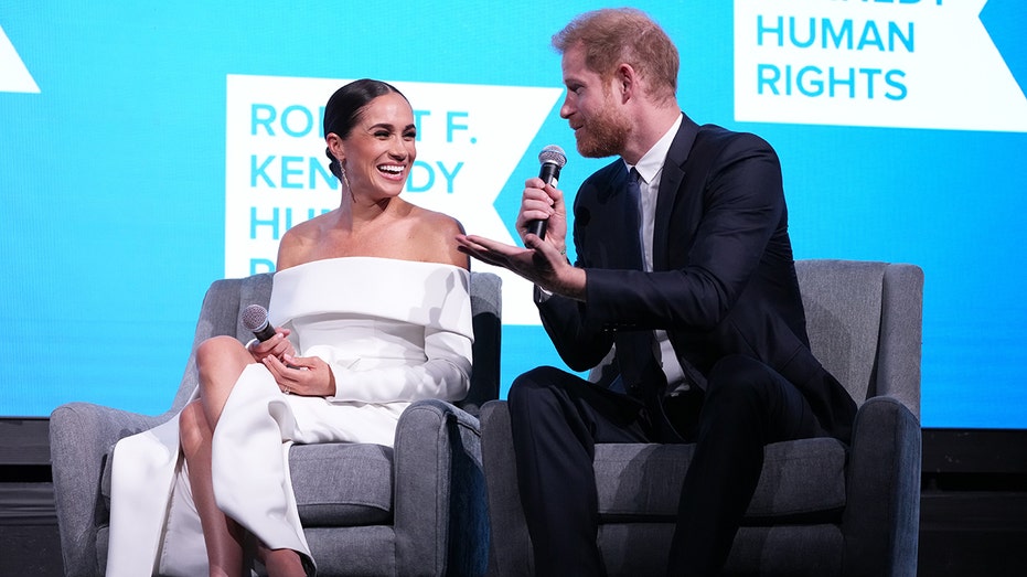 Prince Harry and Meghan on stage