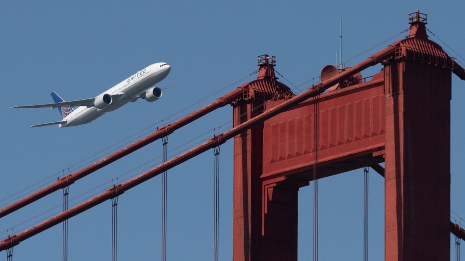 A United Airlines Boeing 777-300ER flies