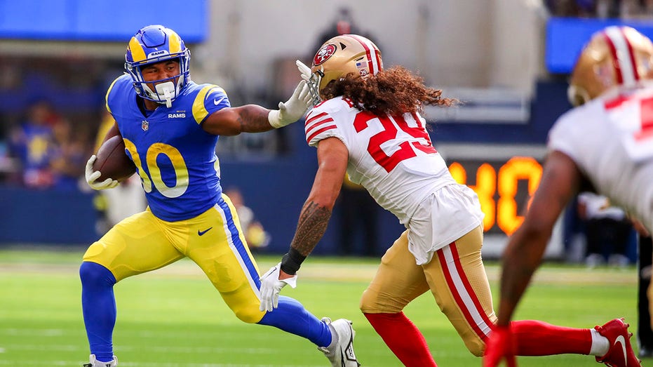 Ronnie Rivers runs with the football during a game