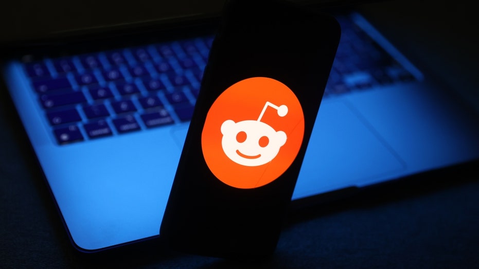 The Reddit logo on a phone