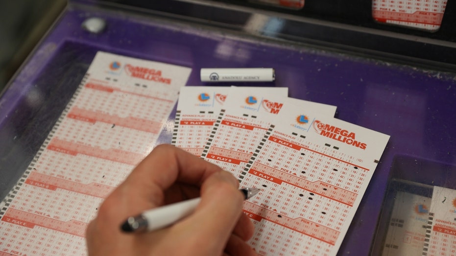 A person plays Mega Millions lottery