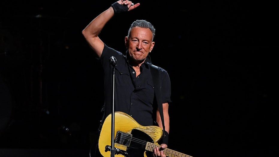 Bruce Springsteen plays guitar at concert