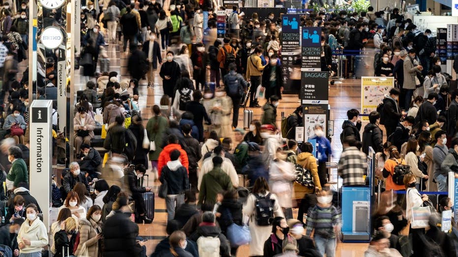 Wide shot of travelers in airport