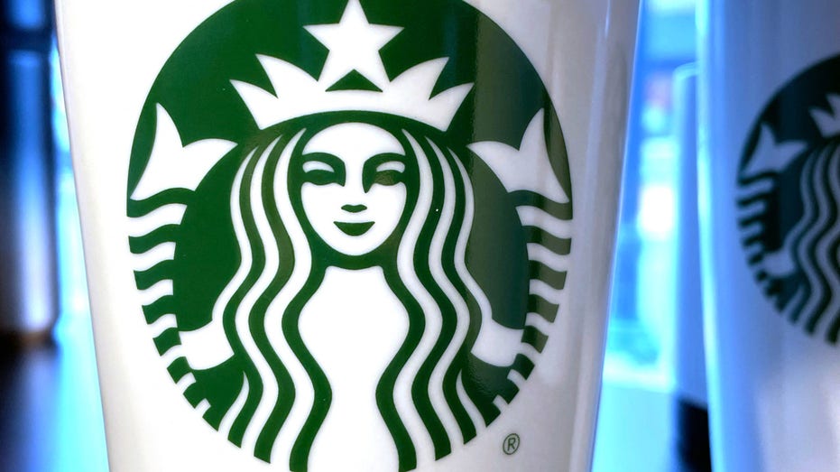 The Starbucks emblem on reusable coffee cup