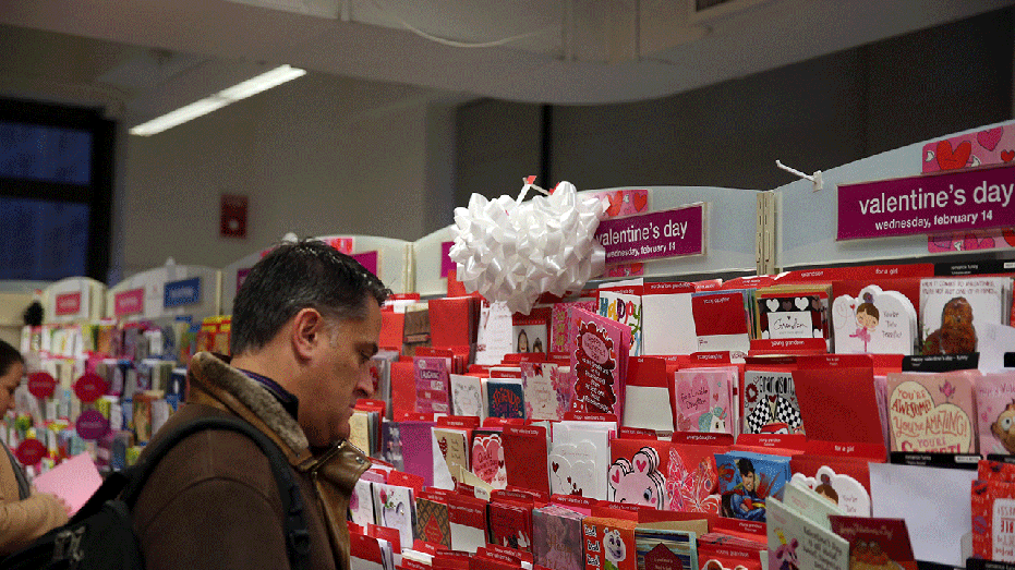 Man purchasing Valentine's Day cards at the store