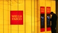 A man uses an automated teller machine (ATM) at a Wells Fargo Bank branch on a rainy morning in Washington Jan. 17, 2012.  