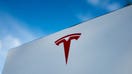 A close-up of Tesla Motors logo against a bright blue sky in Pleasanton, California, on July 23, 2018. 