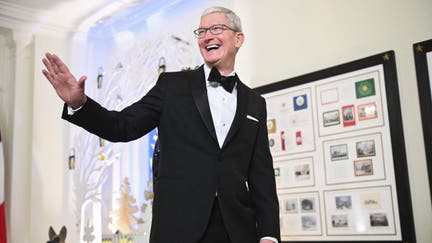 Chief Executive Officer of Apple Tim Cook (L) arrives at the White House to attend a state dinner honoring French President Emmanuel Macron, in Washington, DC, on December 1, 2022. 