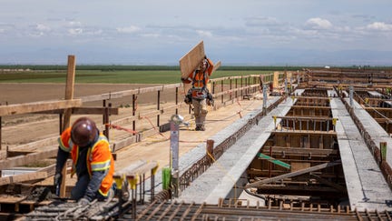 Contractors work on the McCombs Avenue grade separation during construction of a high-speed rail project in Kern County, California, U.S., on Tuesday, April, 19, 2022. California High Speed Rail Authority's 2022 business plan estimates that the full 500-mile high-speed system between Los Angeles and San Francisco will cost as much as $105 billion, up from $100 billion two years ago, according to the Los Angeles Times. Photographer: David Paul Morris/Bloomberg via Getty Images  - Fox Business News