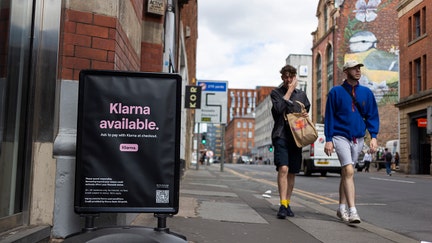 Members of the public pass by a floor advertisement for tech firm Klarna, a European ecommerce company which allows users to buy now, pay later, or pay in instalments, as the company's valuation fell from $46 billion to $6.7 billion in its latest round of investor fundraising, on 14th July, 2022 in Manchester, United Kingdom. (photo by Daniel Harvey Gonzalez/In Pictures via Getty Images) - Fox Business News