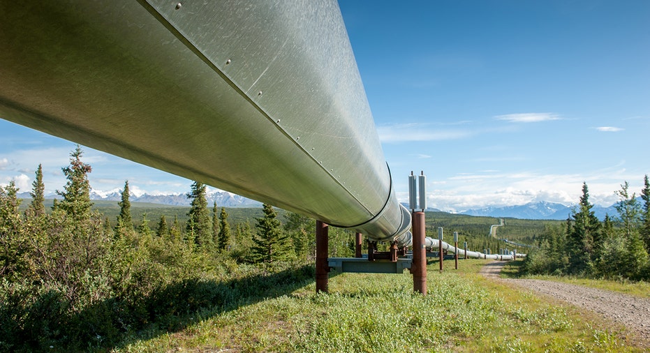 Alaska pipeline with mountains in background