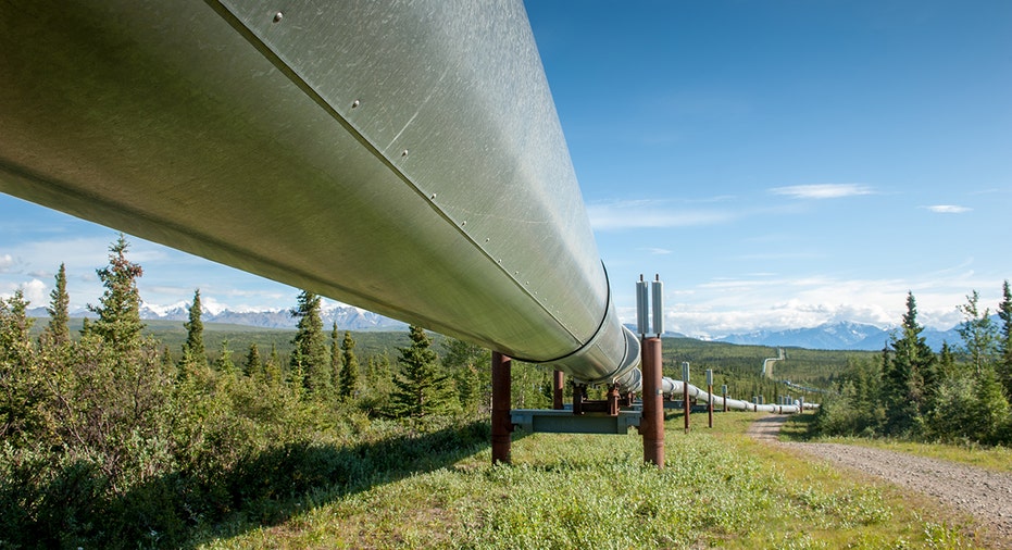 Alaska pipeline with mountains in background