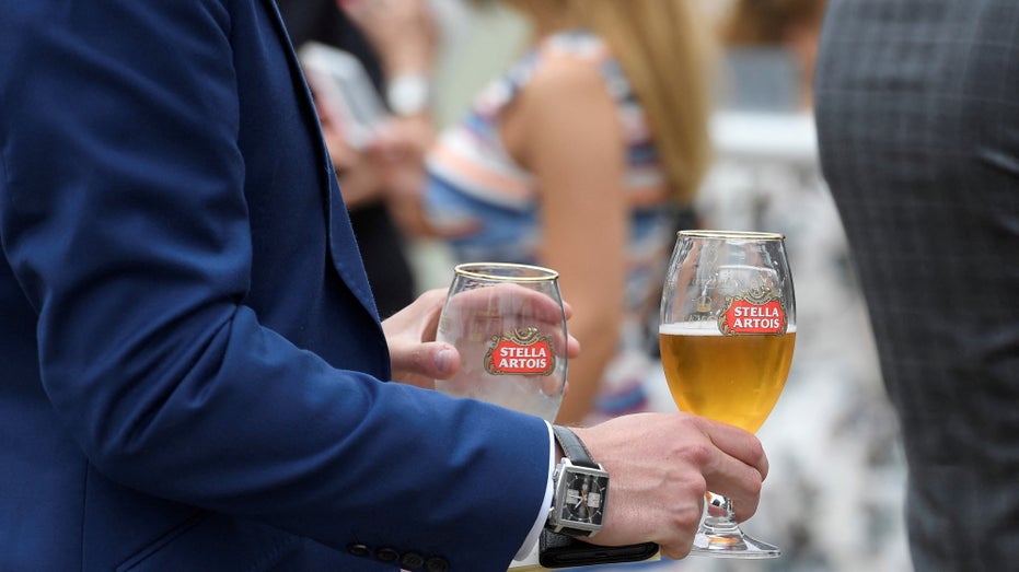 Racegoers drinks Stella Artois beer at the Ascot racecourse at Ascot