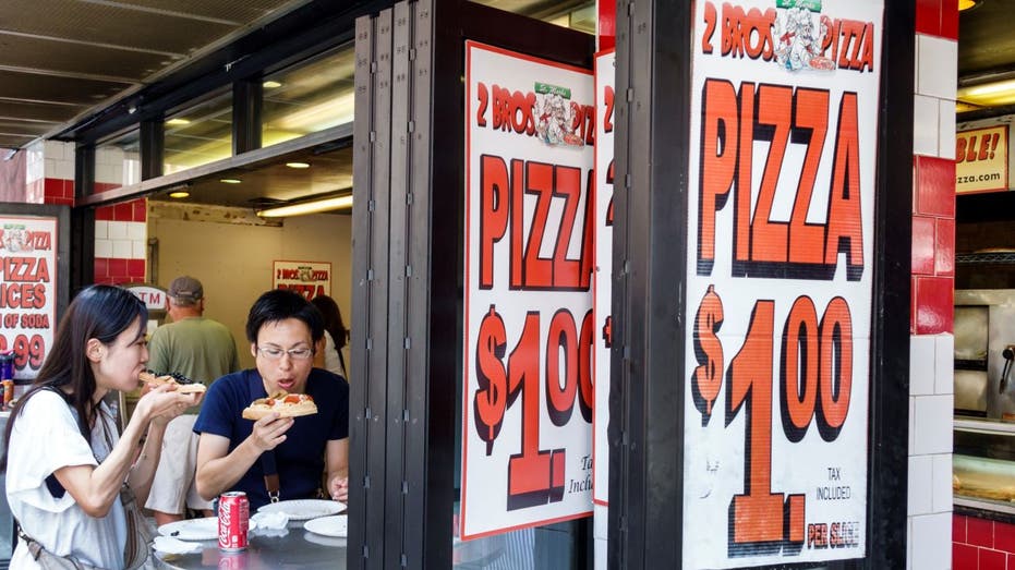 Couple sitting eating pizza