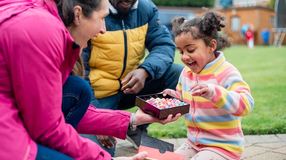 Little girl receiving Easter candy