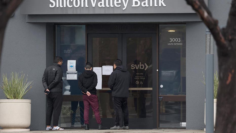 Customers at SVB line up outside of the bank