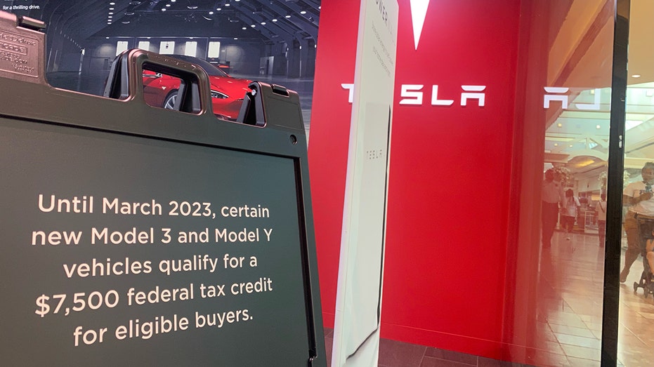 Tesla electric vehicles tax credit sign