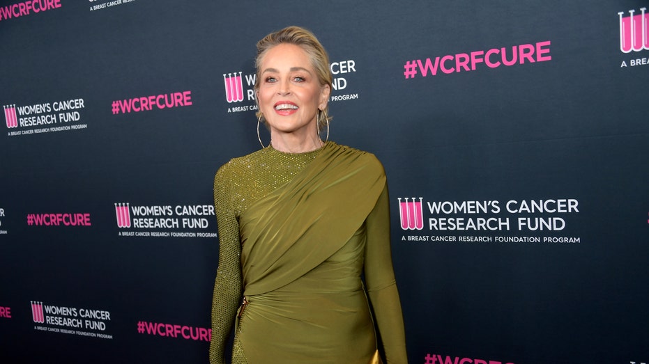 Sharon Stone wears an olive green dress on the red carpet