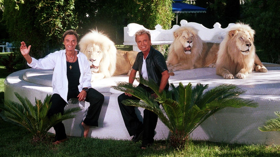 Siegfried and Roy posing with lions in Little Bavaria