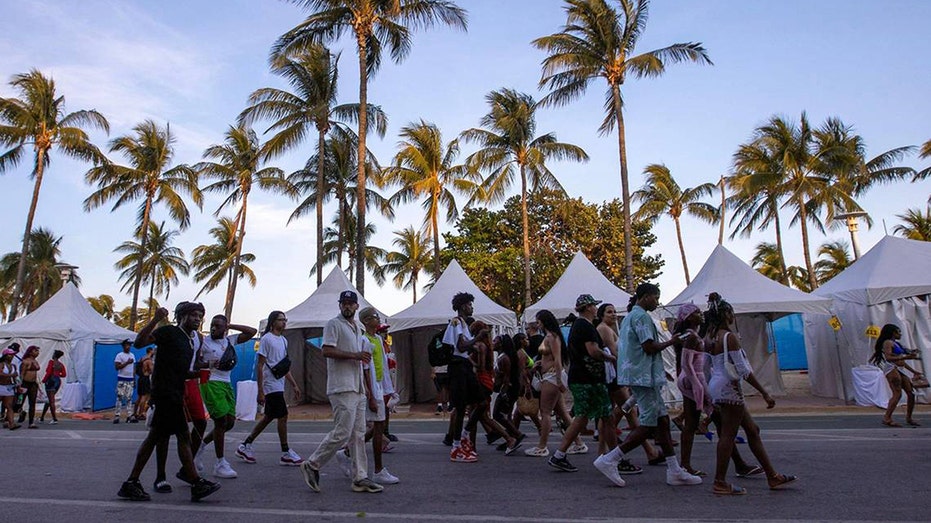 People walk on Ocean Drive, Miami