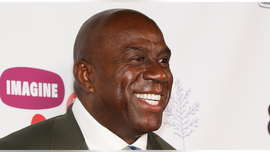 Magic Johnson smiles on red carpet