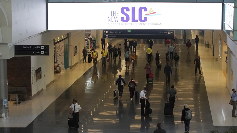 Travelers and pilots walk through Salt Lake City International Airport