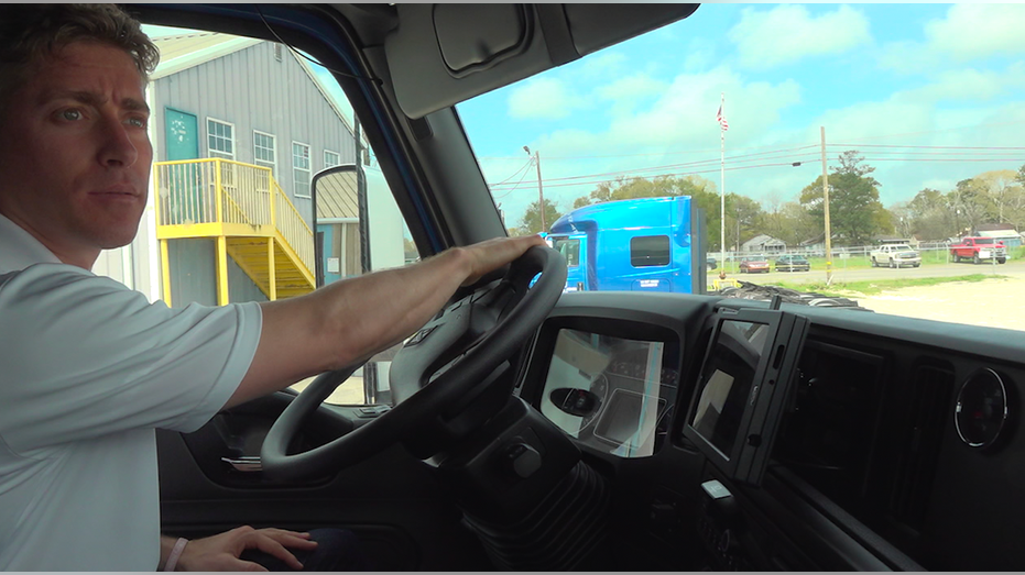 Man behind the steering wheel of a big rig