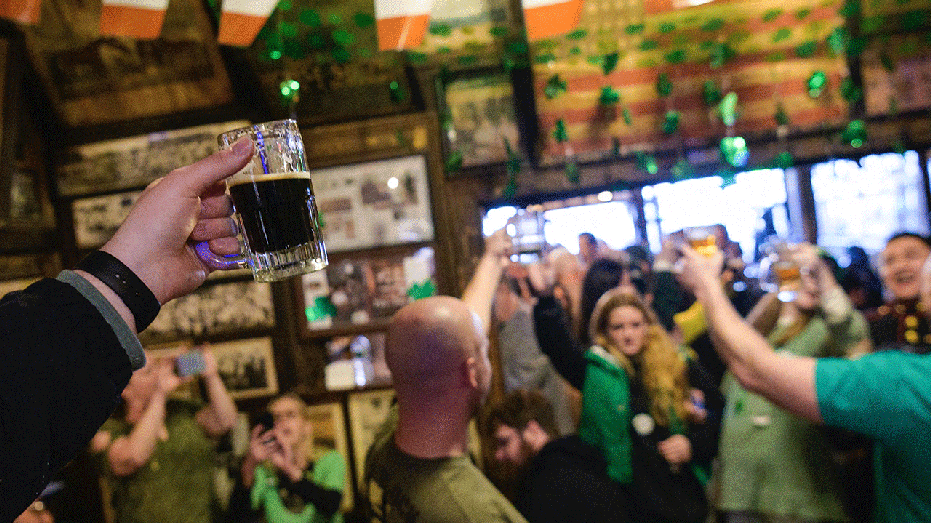 People holding up beers