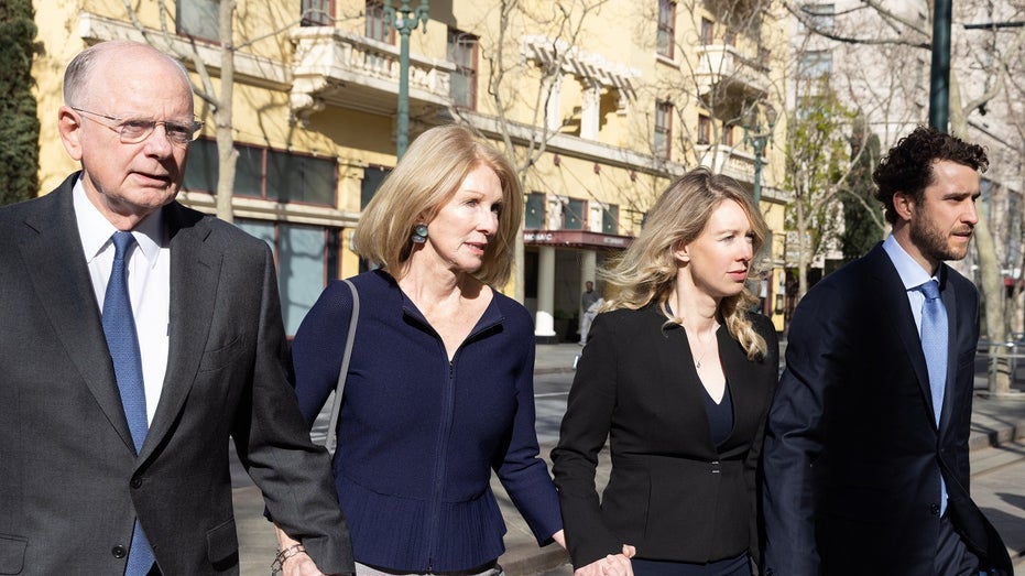 Elizabeth Holmes and family members arrive at court
