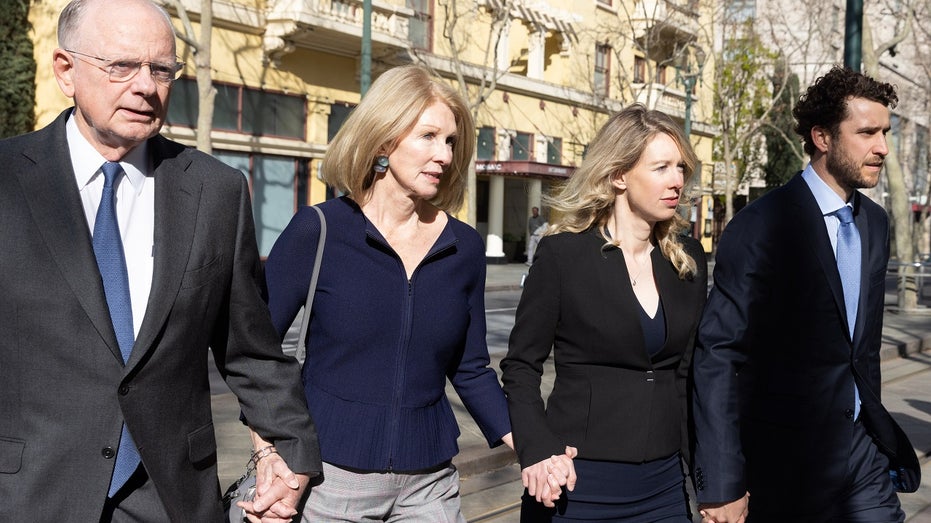 Elizabeth Holmes and family members arrive at court