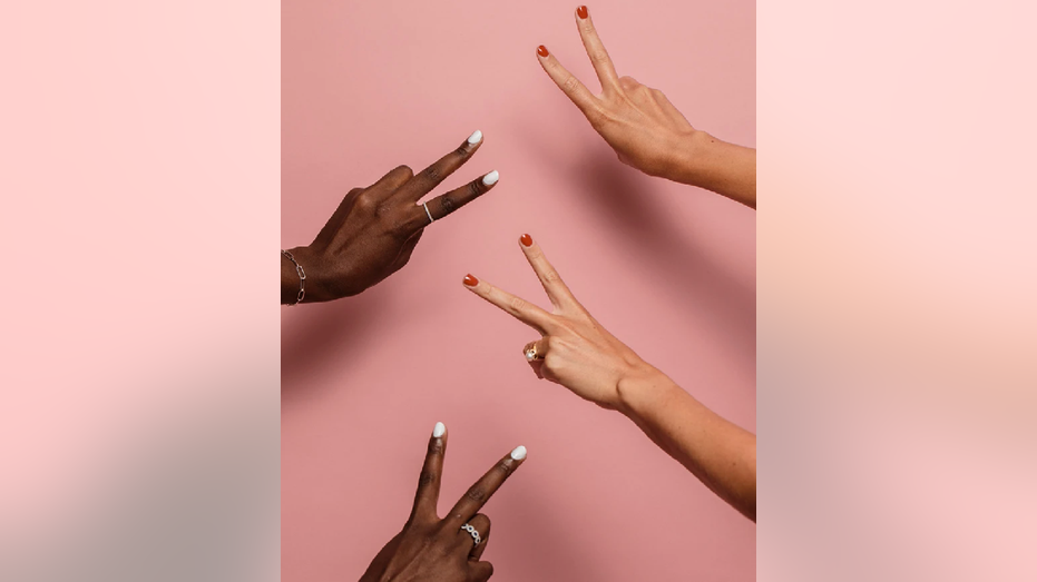 Two hand models show off their manicures