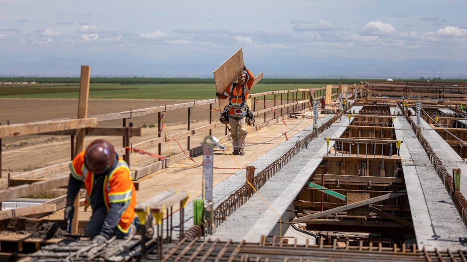 Contractors work on the McCombs Avenue grade separation during construction of a high-speed rail project in Kern County, California, U.S., on Tuesday, April, 19, 2022.