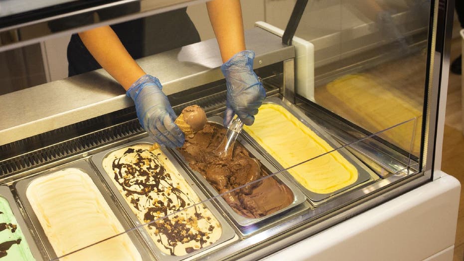 Worker scoops ice cream