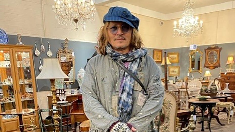 Johnny Depp posing in an antique store