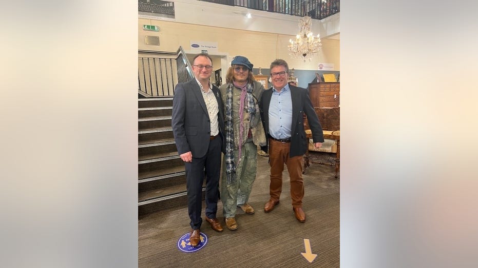 Johnny Depp posing with the owner of Hemswell Antique Centres