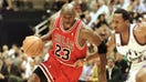 Michael Jordan (L) of the Chicago Bulls goes to the basket past Shandon Anderson of the Utah Jazz 14 June during game six of the NBA Finals at the Delta Center in Salt Lake City, UT. The Bulls lead the best-of-seven series 3-2.