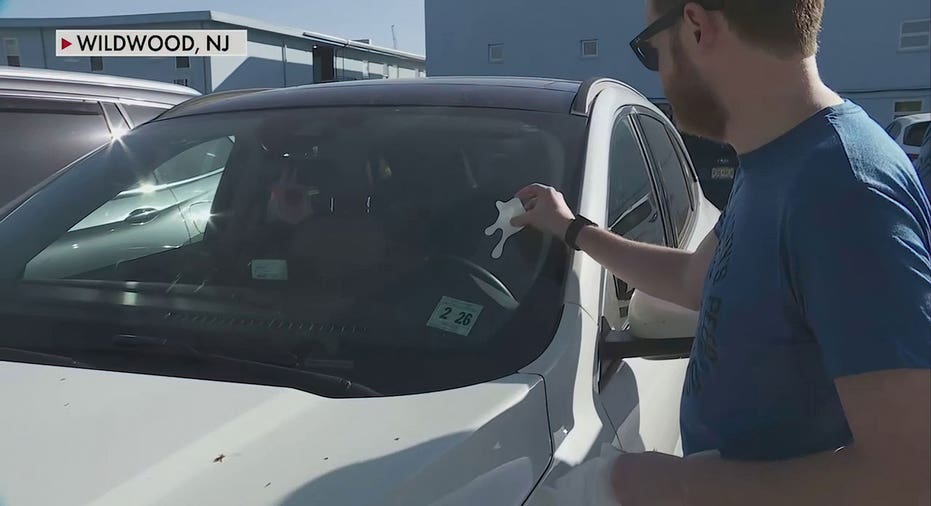 Morey’s worker puts sticker on car